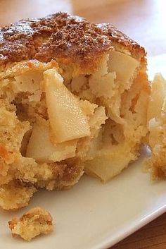 a close up of a piece of food on a plate with some bread crumbs