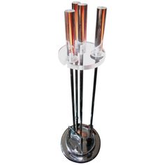 three metal and glass candlesticks on a stand