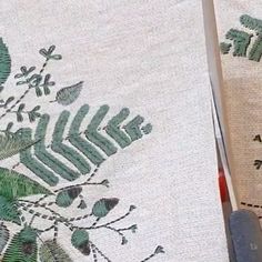 two pieces of fabric with green leaves on them