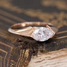 Sleek, fluid, and yes, sexy! This half-bezel ring, centering a gorgeous and rare faint pink marquise cut diamond. We decided to use rich 18kt rose gold for this setting, helping to bring more of the stone's pink color. The diamond has a gorgeous and classic navette shape too, making it the perfect shape for this setting style. On the finger, the ring is simply perfection (and certainly looks bigger than 1.03ct too!). 18kt rose gold Size 6 and fully sizable Diamond measures 8.69 x 5.28 x 3.56 mmG Marquis Diamond Settings, Half Bezel Ring, Modern Mens Rings, Art Jewelry Earrings, Half Bezel, Marquise Diamond Ring, Ring Settings, Bezel Set Ring, Bezel Ring