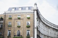 the building has many windows and plants on it