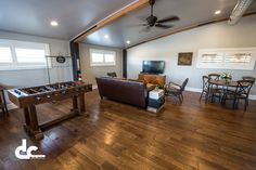 a living room filled with furniture and a foosball table