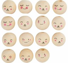 twelve wooden balls with faces and eyes painted on the inside one has pink noses, two are black