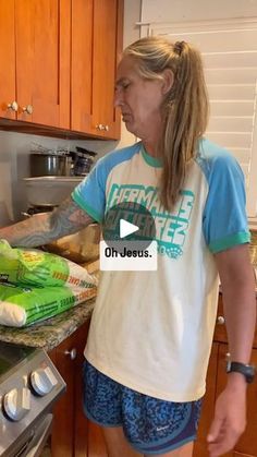 a woman standing in front of a stove with food on the counter next to her