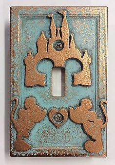 an old light switch plate with mickey mouses on it