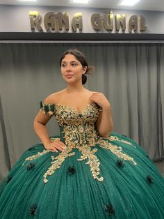 Regal Emerald Green Quinceañera Dress with Gold Embroidery and Off-Shoulder Design Step into your special celebration with this show-stopping emerald green Quinceañera dress that exudes luxury and grace. Crafted with intricate gold embroidery, this gown features a full ball gown skirt that flows beautifully to the floor, complete with a stunning golden lace trim for a truly regal look. The fitted bodice is adorned with delicate golden details and sparkling accents, creating a striking contrast against the deep green fabric. The off-shoulder design adds an element of elegance, framing the neckline with soft, floral accents. Perfect for a quinceañera or any formal event, this gown ensures you'll be the center of attention on your big day. ✨ Key Features: *Color: Deep Emerald Green with Golde Green Ball Gown Quinceanera Dress For Prom Season, Green Ball Gown For Prom Season Quinceanera, Green Ball Gown For Quinceanera, Fitted Green Quinceanera Dress For Debutante Ball, Green Ball Gown For Prom Season, Green Fitted Ball Gown Quinceanera Dress, Fitted Green Ball Gown Quinceanera Dress, Green Evening Dress For Quinceanera And Prom Season, Fitted Green Quinceanera Dress For Prom Season