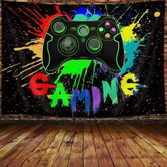 a wall hanging tapestry with a video game controller in front of paint splatters