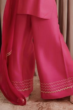 Hot pink silk kurta with mirror and kasab embroidery. Comes with palazzo and an organza dupatta. - Aza Fashions Tissue Silk Palazzo Set With Mirror Work, Pink Silk Palazzo Set With Mirror Work, Silk Palazzo Set With Sheer Dupatta For Celebrations, Silk Palazzo Set For Navratri Celebration, Celebration Silk Sets With Mirror Work, Silk Celebration Sets With Mirror Work, Pink Chanderi Palazzo Set For Celebration, Party Cotton Silk Palazzo Set, Celebration Pink Chanderi Palazzo Set