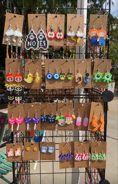 there are many earrings on display at the market