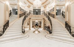 a large foyer with stairs and chandelier