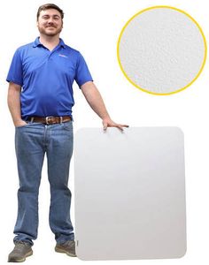 a man standing next to a white board with a yellow circle on it's side