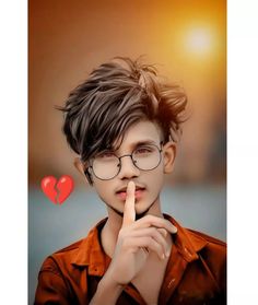 a boy with glasses making a finger sign