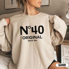 Looking for a unique and personal 40th birthday gift? Look no further than this cute No 40 Original sweatshirt! It's the perfect way to show your loved one how much you care on their special day. Not only is it stylish, but it also makes a great gift for her birthday or any other special occasion.  * Q U I C K * F A C T S * ✺ 50% cotton, 50% polyester ✺ Medium-heavy fabric ✺ Wash and dry normally (on cool for best results) ✺ Product color may slightly vary due to photographic lighting sources or Funny 40th Shirts, 40th Themes For Women, 45th Birthday Shirt Ideas For Women, Funny 50 Year Old Shirts, 40th Female Birthday Ideas, Big 40 Birthday Ideas For Women, 40th Birthday Sweatshirt, Birthday Sweatshirt Ideas, 40tg Birthday Ideas For Women