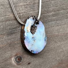 Presenting a captivating Australian Boulder Opal side-drilled pendant that effortlessly combines natural beauty and timeless elegance. This exquisite piece showcases an Australian Boulder Opal measuring 24mm in height and 18mm in width. To enhance your gifting experience, all our jewelry arrives beautifully wrapped, ensuring your purchase is a delight to receive. Boulder Opal, a true gem of Queensland, Australia, originates from within ironstone boulders where precious opal forms in intricate ve Nature-inspired Opal Jewelry Gift, Untreated Nature-inspired Pendant Jewelry, Nature-inspired Necklace With Large Stone For Gift, Untreated Teardrop Pendant Necklace As A Gift, Untreated Teardrop Pendant Necklace For Gifts, Minimalist Jewelry With Large Stone For Gift, Untreated Round Pendant Jewelry Gift, Artisan Opal Necklaces As Gifts, Artisan Opal Necklaces For Gifts