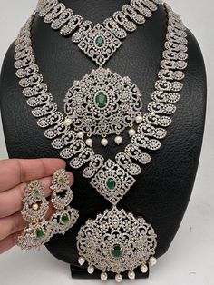 American Diamond Finish Ganga Jamuna Polish Floral Green Stone Long Short Necklace Combo Set . Diamond finish combo necklace perfect for bridal wear, house warmings, half saree function or classical dance. Premium quality diamond look a like. Long Necklace Length : Approx 24 Inches;  Necklace Length : Approx 16 Inches;  Earrings Length : 2.25 Inches; Push back Ready to ship from Massachusetts, USA If you have any questions please let us know. Bollywood Bridal Necklace For Marriage On Diwali, Bollywood Bridal Necklace For Marriage And Diwali, Bollywood Bridal Necklace For Marriage During Diwali, Bollywood Style Bridal Necklace For Marriage During Diwali, Silver Bridal Necklace With Zari Work For Wedding, Temple Jewelry Bridal Sets For Reception With Pallu, Indian Bridal Necklace, Saree Function, Jewelry Indian Wedding