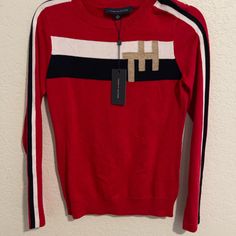 Brand New Tommy Hilfiger Sweater In Beautiful Red Color With Classic Tommy Hilfiger Stripes Down Arms And Monogram On Right Hand Side Of Chest Area. This Sweater Is Lightweight Making It Versatile For Spring, Autumn, And Winter And Also Makes It A Great Layering Piece. This Red Women’s Sweater Is Brand New With Tags, Has Never Been Worn, And Comes From A Smoke Free Home. Fast Shipping! Offers Welcome Trendy Red Tommy Hilfiger Top, Tommy Hilfiger Red Long Sleeve Top, Trendy Tommy Hilfiger Tops For Fall, Crewneck Sweatshirt Women, Polka Dot Sweater, Tommy Hilfiger Shorts, Tommy Hilfiger Sweater, Long Sleeve Pullover Sweater, Pink Crewneck