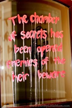 a sign in a window that says the chamber of secrets has been opened opening to reveal the