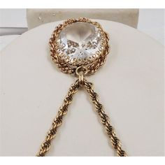 This is part of Chairish’s Costume Jewelry assortment.  1950s goldtone filigree large faceted unfoiled open-backed clear rhinestone pendant necklace with security clasp. Marked "Napier" on a jump ring near the clasp. Pendant measures:  1 3/4 inches long by 1 3/8 inches wide. Chain doubled is 10 1/2 inches long. Excellent condition. The matching earrings are shown on pg. 212 of Melinda L. Lewis & Henry Swen's book "The Napier Co.: Defining 20th Century American Costume Jewelry." Vintage Round Faceted Jewelry, Antique Gold Crystal Jewelry, Victorian Gold Faceted Jewelry, Vintage Crystal Pendant Jewelry, Accessories Jewelry Necklace, Modern Branding, Clear Rhinestones, Jump Rings, Vintage 1950s