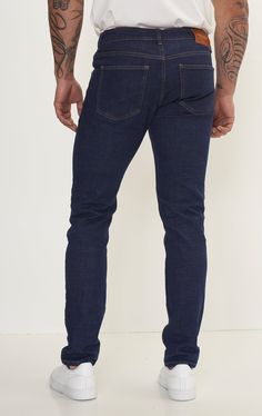 Fitted tapered jeans are a versatile and stylish choice for any wardrobe, offering a flattering silhouette and a modern look. These jeans are crafted from high-quality denim with a hint of stretch, ensuring both comfort and durability. The fitted style hugs the body in all the right places, accentuating curves while providing a sleek and streamlined appearance. The tapered leg adds a contemporary touch, narrowing towards the ankle for a flattering fit that pairs well with both sneakers and boots. Whether you're dressing for a casual day out or a night on the town, fitted tapered jeans can easily be dressed up or down. Pair them with a crisp button-down shirt and blazer for a polished look, or opt for a cozy sweater and sneakers for a more relaxed vibe. With their timeless appeal and versat Slim Fit Mid-rise Jeans For Business Casual, Business Casual Slim Fit Mid-rise Jeans, Mid-rise Slim Fit Jeans For Business Casual, Business Casual Mid-rise Slim Fit Jeans, Mid-rise Blue Jeans For Business Casual, Blue Mid-rise Jeans For Business Casual, Modern Tapered Straight Leg Jeans, Slim Fit Rigid Denim Dark Wash Bottoms, Slim Fit Dark Wash Rigid Denim Bottoms