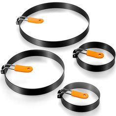 three black and orange circles with handles attached to each other on a white background 3d rendering