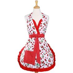 a white and red apron with cherries on it, sitting on a mannequin