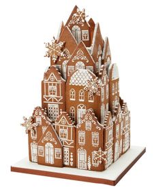 a gingerbread house with snowflakes on it's roof is shown in front of a white background