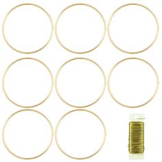 six gold colored hoops and some wire on a white background