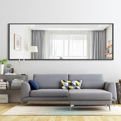 a living room filled with furniture and a large mirror