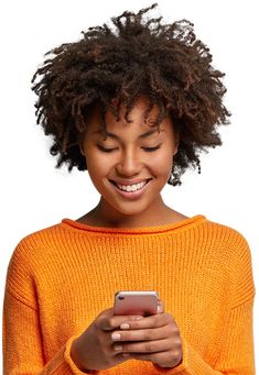 a woman smiling while looking at her cell phone