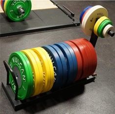 the barbells are lined up in different colors