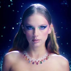 a woman with blue eyes wearing a choker necklace and diamond jewelry on her neck