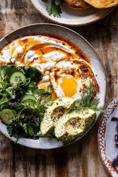 two plates filled with food on top of a wooden table