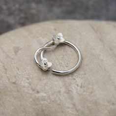 a silver ring sitting on top of a rock