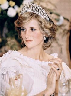 a woman wearing a tiara sitting at a table