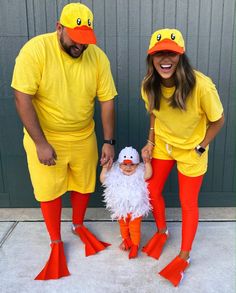 two people dressed in yellow and orange standing next to each other