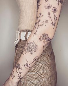 a woman's arm with flowers on it