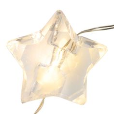 a white star shaped light hanging from a cord