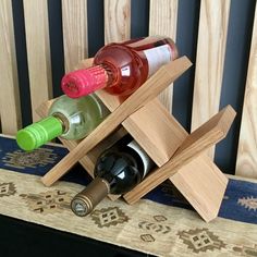 three bottles of wine in a wooden holder