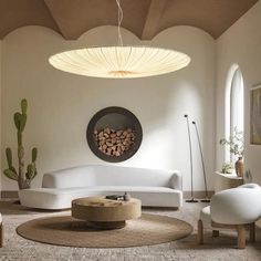 a living room filled with white furniture and lots of windows