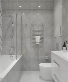 a bathroom with a toilet, sink and bathtub next to a wall mounted towel dispenser