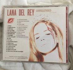 the cd cover for lana del rey unrecessed is lying on a white sheet