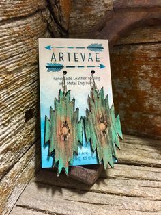 the book artievae has been placed on top of a wooden table with an arrow