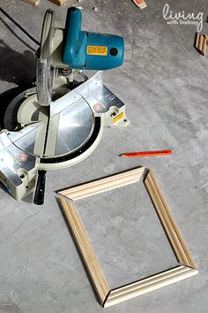 a table saw and some wood planks next to a piece of plywood on the ground