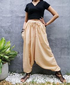 "The harem style trousers made from cotton fabric 100%with an elasticated smock waist and ankles they provide a comfortable lightweight fit, perfect for casual wear, festivals, yoga, holidays as well as pairing with a plain top to get that popular look. D I S C O U N T & P R O M O T I O N ❤ Buy 2 or more items, get 10% off ❤ Buy 4 or more items, get 15% off ENTER the coupon code: IYARA015 ❤ Buy 6 or more items, get 15% off ENTER the coupon code: IYARA020 PLEASE NOTE I can not apply a discoun Beige Cotton Harem Pants For Summer, Baggy Beige Cotton Harem Pants, Beige Baggy Cotton Harem Pants, Bohemian Cotton Wide-leg Harem Pants, Cotton Hippie Harem Pants For Yoga, Beige Cotton Harem Pants With Pockets, Festival Wide Leg Harem Pants With Elastic Waistband, Loose Fit Harem Pants For Festival, Casual Harem Pants For Festivals