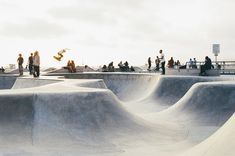 skateboarders are riding their boards at a skate park