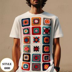 a man standing in front of a wall wearing a white t - shirt with multicolored squares on it