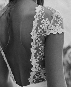 black and white photograph of a woman with her back to the camera, wearing a wedding dress