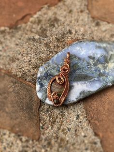 This lovely blue jasper stone is wire wrapped in copper wire. This wire wrap pendant is very elegant and unique. The bail is very simplistic with weaving curling down the front and sides of this polished stone. I added a unique bead at the bottom within the weaving to add character. This pendant would be a great gift for friends and loved one. Many individuals use crystals as healing stones. It is up to you decide what your intentions are.  Dimensions: 2" Tall 1" wide .25" thick I price my wire weaved pendants based on the weight of the stone, by price per gram, and how long it took me to wire wrap each stone, as well as the price on the potency and quality of my minerals, and the amount of materials it took. I find my research from The Audubon Society Field Guide to North American Rocks a Handmade Copper Wire Teardrop Pendant Jewelry, Hand Wrapped Agate Pendant Jewelry, Ocean Jasper Wire Wrapped Pendant Necklaces, Wire Wrapped Ocean Jasper Pendant Necklaces, Wire Wrapped Ocean Jasper Pendant Jewelry, Wire Wrapped Ocean Jasper Pendant Necklace, Artisan Wire Wrapped Chrysocolla Jewelry, Bohemian Ocean Jasper Jewelry For Gifts, Bohemian Ocean Jasper Jewelry As Gift