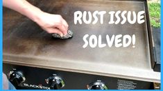 a person is touching the rust on top of an oven that says rust issue solve