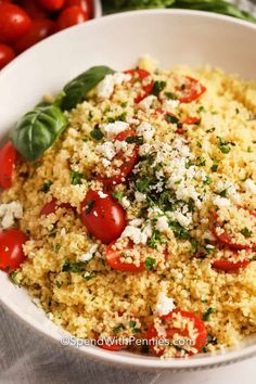 a white bowl filled with rice and tomatoes